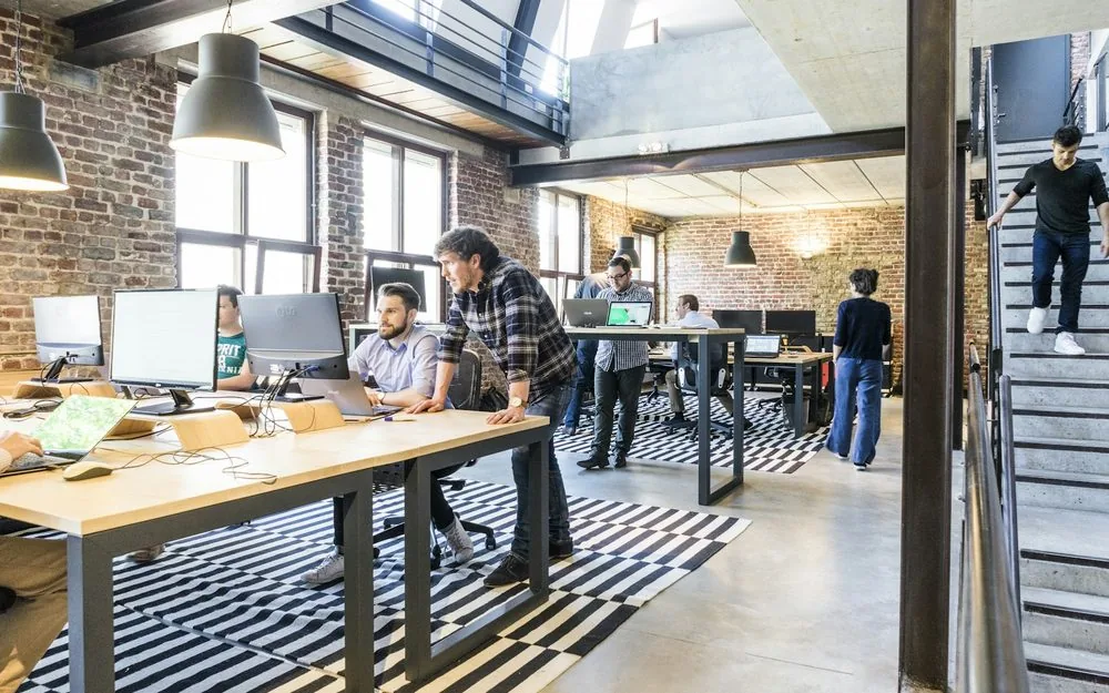 Technology workspace with monitors and notebooks
